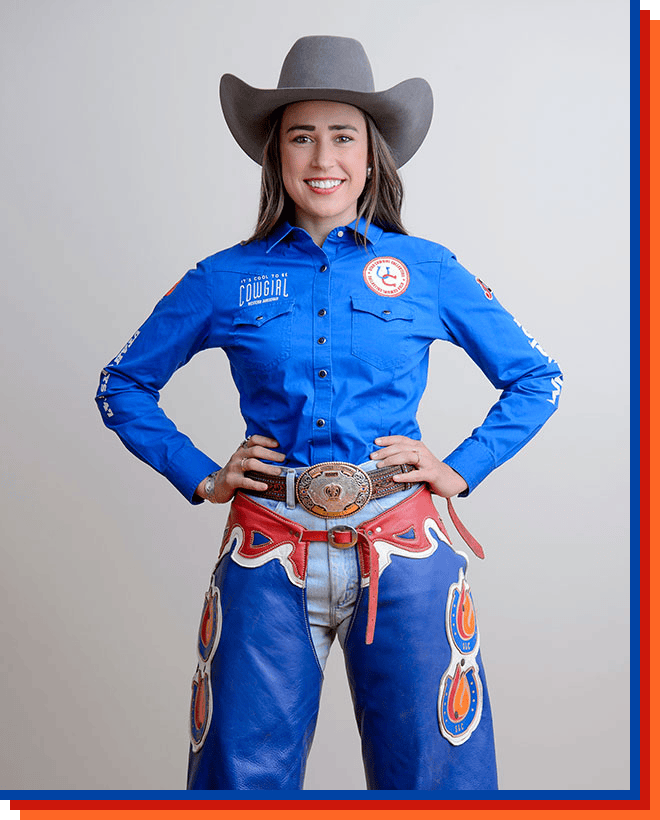 Madison Mcquivey smiling at the camera, posing wearing a cowgirl hat and a blue shirt.